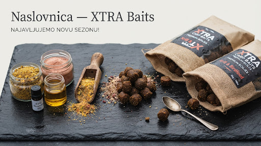 Artisanal macro photography of premium XTRA carp boilie ingredients, birdfood, krill flour, essential oils, and rolled bait bags on dark slate.