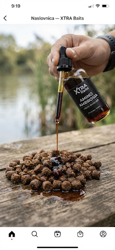 Liquid bait booster attractor bottle with dropper, dark amber amino liquid pouring slowly onto fishing bait pellets