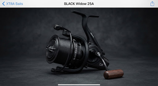 Daiwa Black Widow carp reel with big pit matte black spool and wooden handle knob, elegant dark studio angling photography