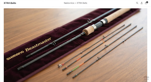 Shimano Beastmaster feeder rod sections in velvet sheath with interchangeable sensitive carbon quivertips lying on polished wood.